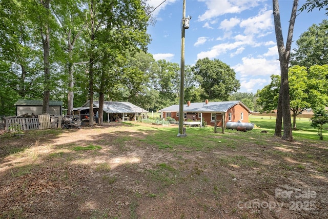 2320 Doster Rd, Monroe, NC 28112 - view of yard featuring a carport, an outbuilding, and view of scattered trees