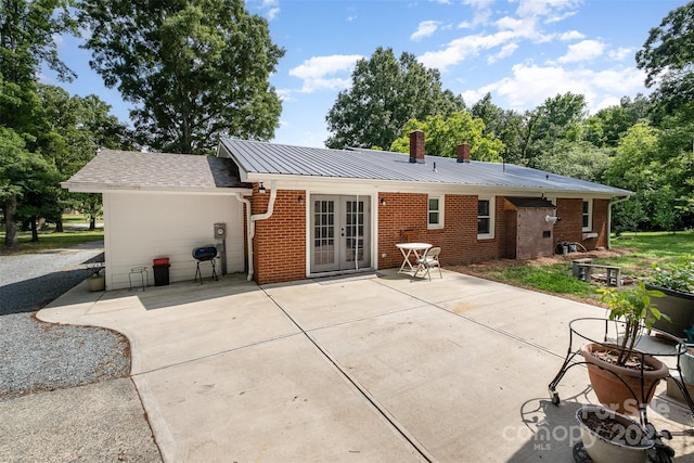 2320 Doster Rd, Monroe, NC 28112 - rear view of house featuring french doors, brick siding, a patio, and a chimney