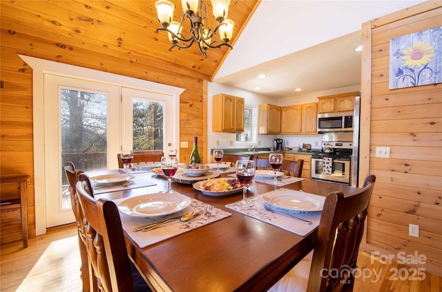 693 Blackberry Ridge Rd, Burnsville, NC 28714 - dining room with a chandelier, light wood finished floors, wooden walls, lofted ceiling, and recessed lighting