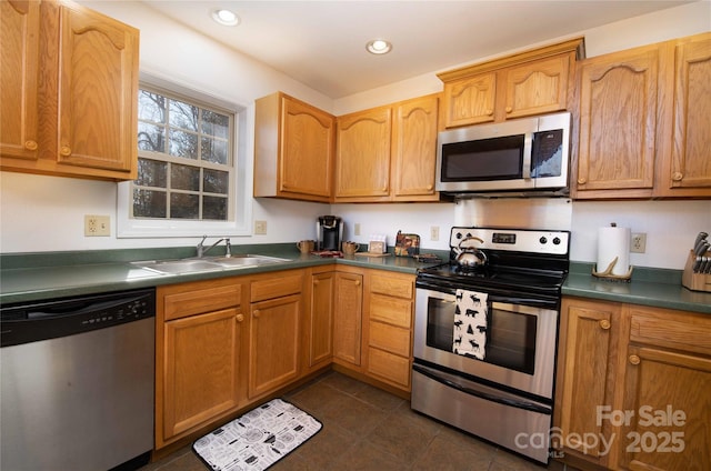 693 Blackberry Ridge Rd, Burnsville, NC 28714 - kitchen featuring stainless steel appliances, a sink, dark countertops, recessed lighting, and dark tile patterned flooring