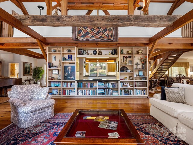 1360 Skunk Hollow Rd, Campobello, SC 29322 - living area featuring wood finished floors, beam ceiling, stairway, and high vaulted ceiling