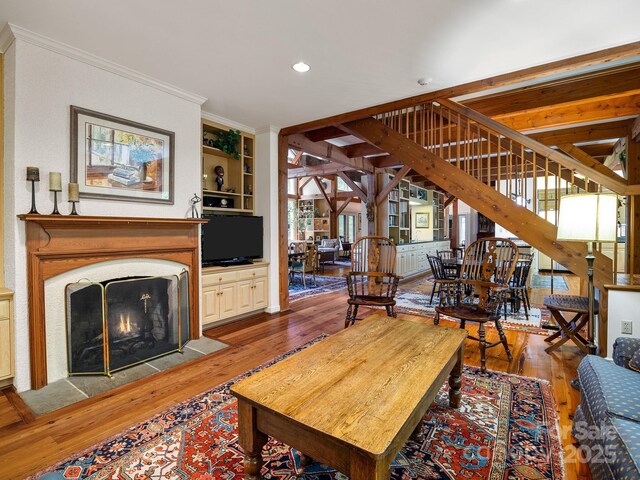 1360 Skunk Hollow Rd, Campobello, SC 29322 - living room with wood finished floors, crown molding, recessed lighting, a fireplace with flush hearth, and built in features