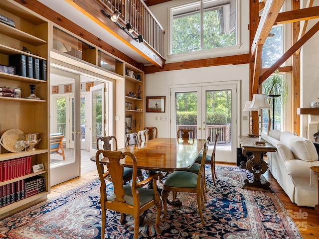 1360 Skunk Hollow Rd, Campobello, SC 29322 - dining area featuring french doors, plenty of natural light, a high ceiling, and light wood-style floors