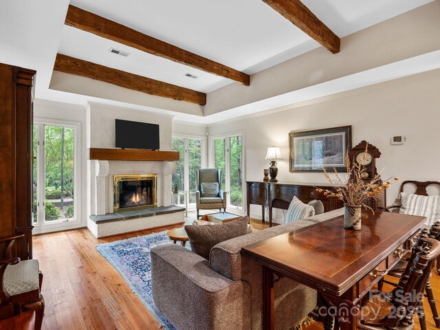 1360 Skunk Hollow Rd, Campobello, SC 29322 - living area with beamed ceiling, a large fireplace, plenty of natural light, and light wood-type flooring