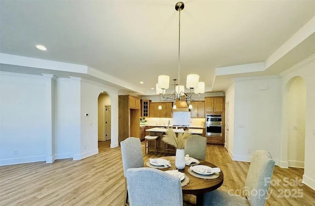 409 Newstyle Way, Gastonia, NC 28056 - dining space with arched walkways, a chandelier, light wood-type flooring, recessed lighting, and baseboards