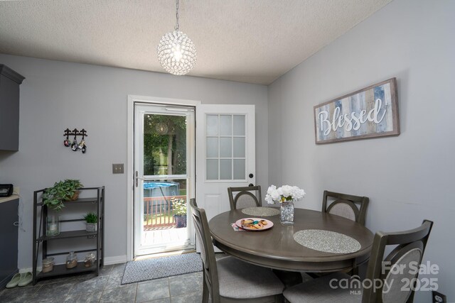 103 Poplar Trl, Rockwell, NC 28138 - tiled dining area featuring a textured ceiling and baseboards