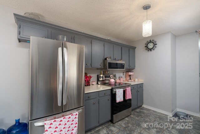103 Poplar Trl, Rockwell, NC 28138 - kitchen featuring appliances with stainless steel finishes, light countertops, gray cabinets, pendant lighting, and baseboards