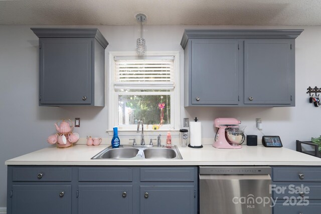 103 Poplar Trl, Rockwell, NC 28138 - kitchen with stainless steel dishwasher, a sink, light countertops, decorative light fixtures, and a textured ceiling