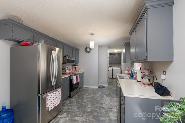 103 Poplar Trl, Rockwell, NC 28138 - kitchen with stainless steel appliances, separate washer and dryer, a sink, light countertops, and gray cabinetry