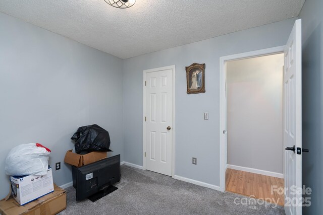 103 Poplar Trl, Rockwell, NC 28138 - bedroom featuring a textured ceiling, baseboards, and carpet flooring