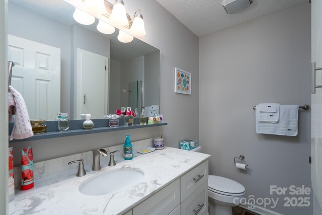 103 Poplar Trl, Rockwell, NC 28138 - bathroom featuring vanity, toilet, and a textured ceiling