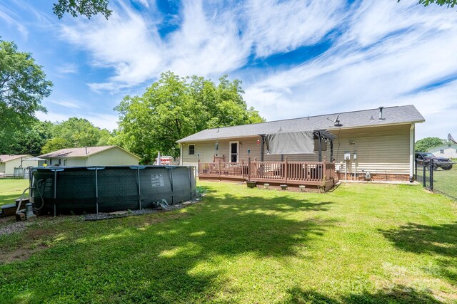 103 Poplar Trl, Rockwell, NC 28138 - back of property featuring a wooden deck and an outdoor pool