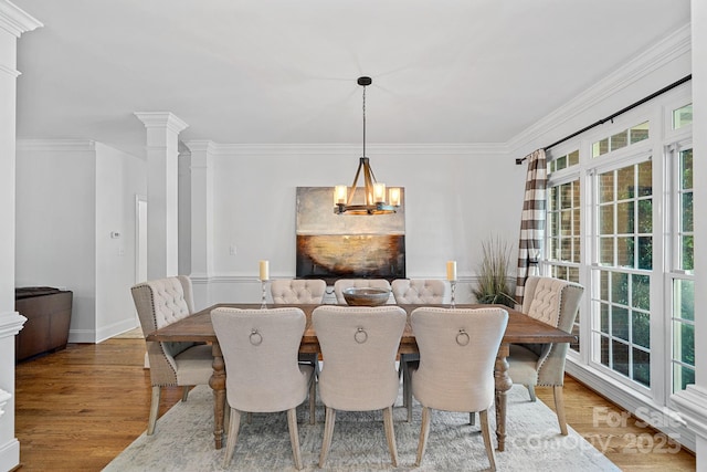 3506 Cardiff Ln, Matthews, NC 28104 - dining room with a chandelier, healthy amount of natural light, wood finished floors, ornamental molding, and ornate columns