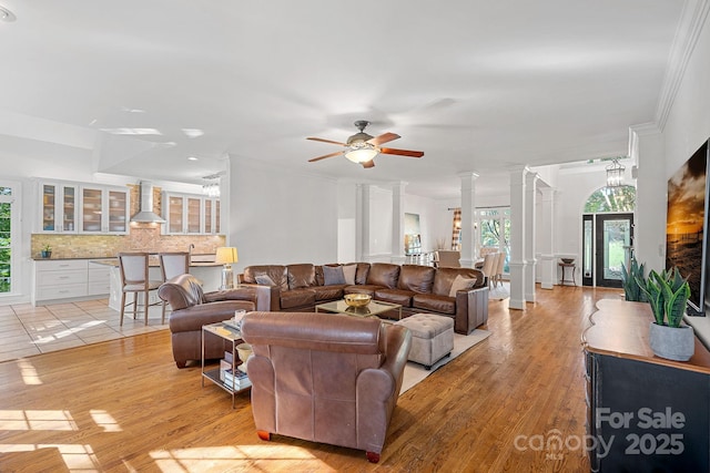 3506 Cardiff Ln, Matthews, NC 28104 - living area with ornate columns, ceiling fan, light wood-style flooring, and ornamental molding