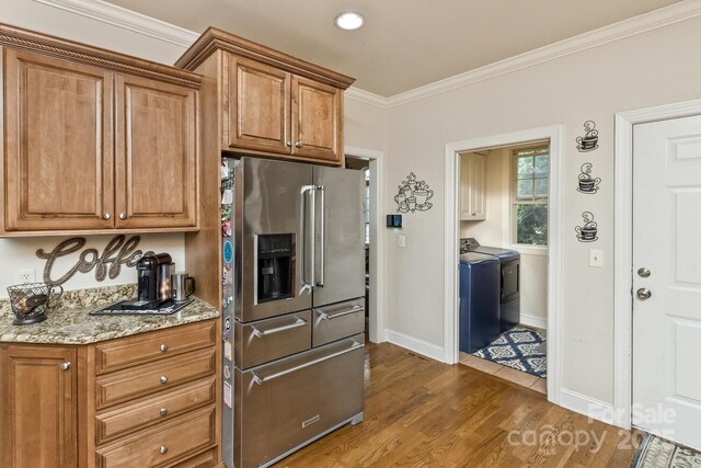 33 Stone House Rd, Arden, NC 28704 - kitchen with stainless steel refrigerator with ice dispenser, independent washer and dryer, baseboards, dark wood finished floors, and ornamental molding
