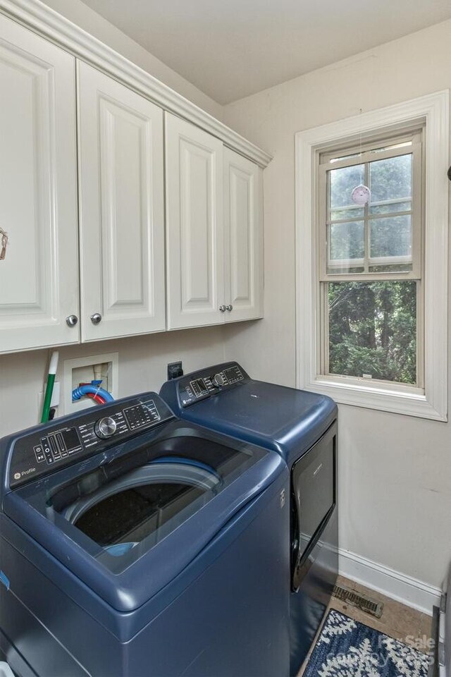 33 Stone House Rd, Arden, NC 28704 - washroom featuring washing machine and dryer, cabinet space, and baseboards