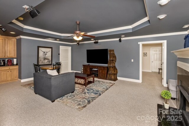 33 Stone House Rd, Arden, NC 28704 - carpeted living area with a raised ceiling, crown molding, a fireplace, ceiling fan, and baseboards