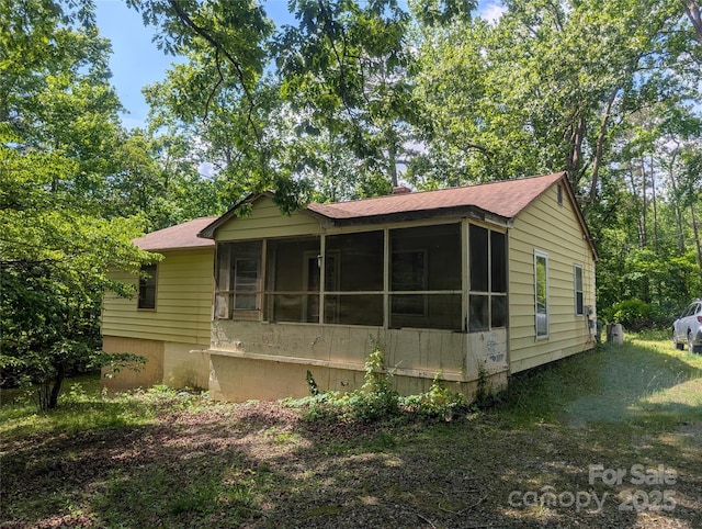 720 New Market Rd, Tryon, NC 28782 - view of front of property with a sunroom and roof with shingles
