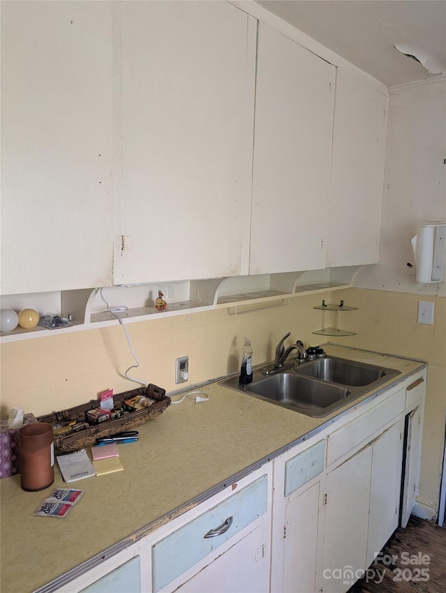 720 New Market Rd, Tryon, NC 28782 - kitchen with light countertops, a sink, white cabinets, and tasteful backsplash