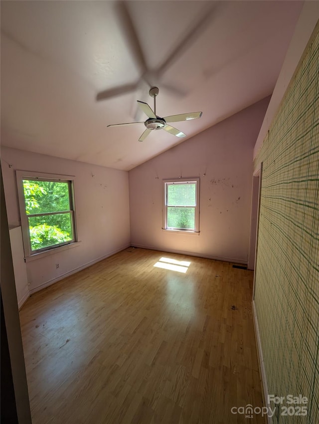 720 New Market Rd, Tryon, NC 28782 - empty room with vaulted ceiling, wood finished floors, a ceiling fan, and baseboards