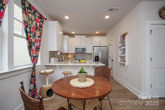 711 Beaty St, Davidson, NC 28036 - dining space with light wood-type flooring, baseboards, and recessed lighting