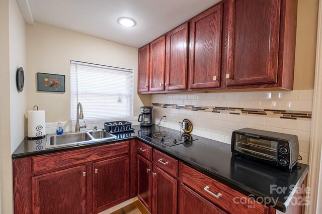 5430 Ela Rd, Whittier, NC 28789 - kitchen featuring a sink, dark brown cabinets, and backsplash