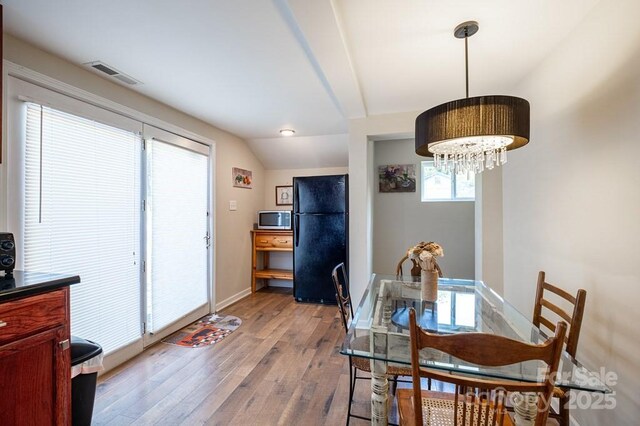 5430 Ela Rd, Whittier, NC 28789 - dining room featuring wood-type flooring, a chandelier, and baseboards