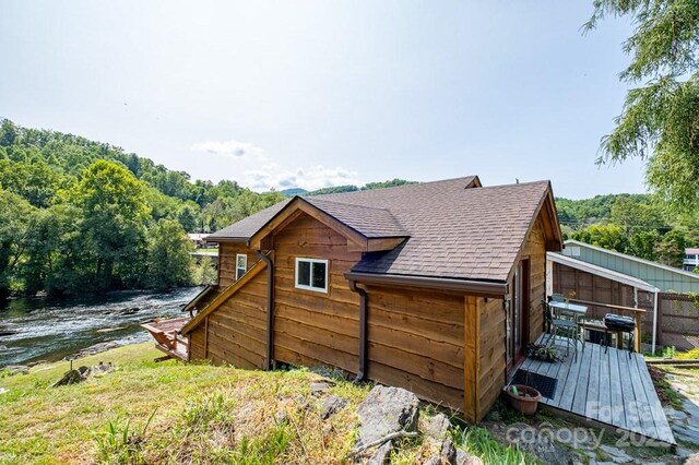 5430 Ela Rd, Whittier, NC 28789 - view of property exterior featuring a deck with water view, a forest view, and roof with shingles