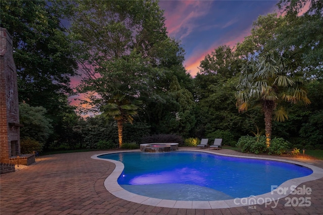 1509 Churchill Downs Dr, Waxhaw, NC 28173 - pool at dusk featuring a patio and a pool with connected hot tub