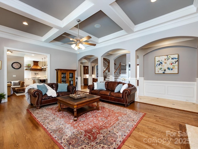 1509 Churchill Downs Dr, Waxhaw, NC 28173 - living room with arched walkways, coffered ceiling, beamed ceiling, wood finished floors, and crown molding