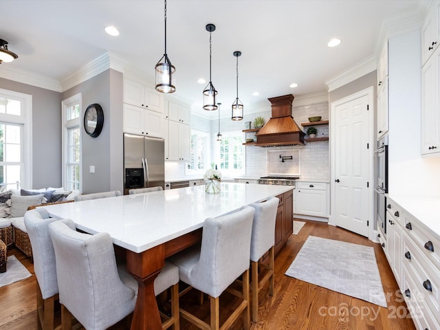 1509 Churchill Downs Dr, Waxhaw, NC 28173 - kitchen with appliances with stainless steel finishes, dark wood-style flooring, premium range hood, ornamental molding, and tasteful backsplash