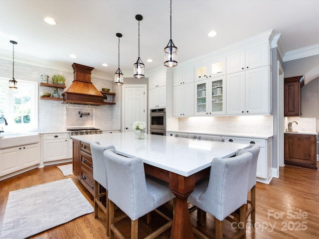 1509 Churchill Downs Dr, Waxhaw, NC 28173 - kitchen featuring double oven, a sink, backsplash, light countertops, and open shelves