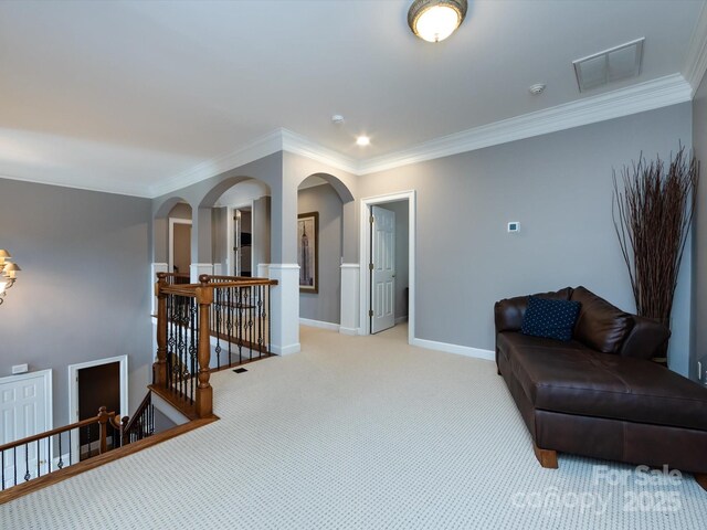 1509 Churchill Downs Dr, Waxhaw, NC 28173 - living area with an upstairs landing, arched walkways, crown molding, light colored carpet, and baseboards