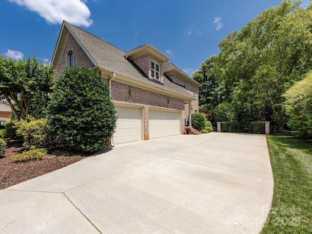 1509 Churchill Downs Dr, Waxhaw, NC 28173 - view of property exterior featuring brick siding, driveway, and a shingled roof