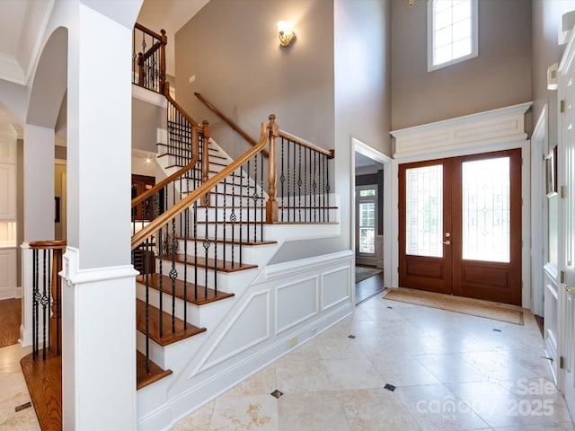 1509 Churchill Downs Dr, Waxhaw, NC 28173 - tiled foyer featuring a towering ceiling, stairway, arched walkways, a decorative wall, and french doors