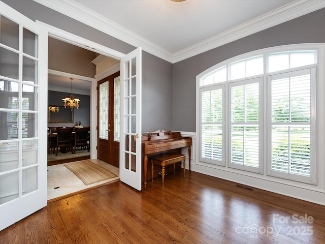 1509 Churchill Downs Dr, Waxhaw, NC 28173 - entryway featuring french doors, crown molding, a chandelier, and wood finished floors