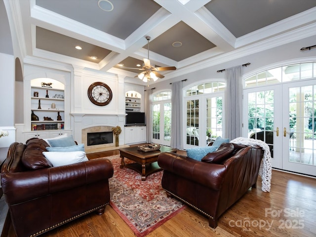 1509 Churchill Downs Dr, Waxhaw, NC 28173 - living room featuring ornamental molding, built in features, a high end fireplace, wood finished floors, and coffered ceiling
