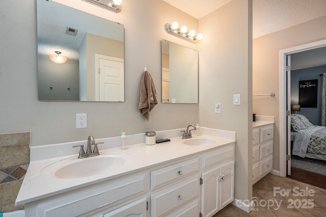 107 Ingonish Dr, Gastonia, NC 28056 - full bathroom with double vanity, ensuite bath, tile patterned floors, and a textured ceiling
