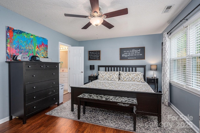107 Ingonish Dr, Gastonia, NC 28056 - bedroom featuring wood finished floors, a textured ceiling, baseboards, ceiling fan, and connected bathroom