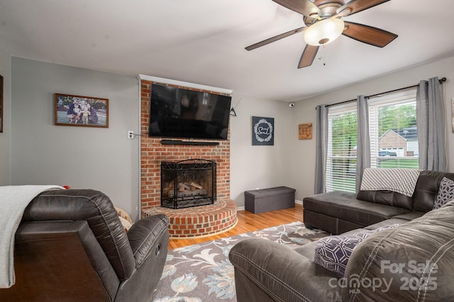 107 Ingonish Dr, Gastonia, NC 28056 - living room with wood finished floors, a ceiling fan, a fireplace, and baseboards