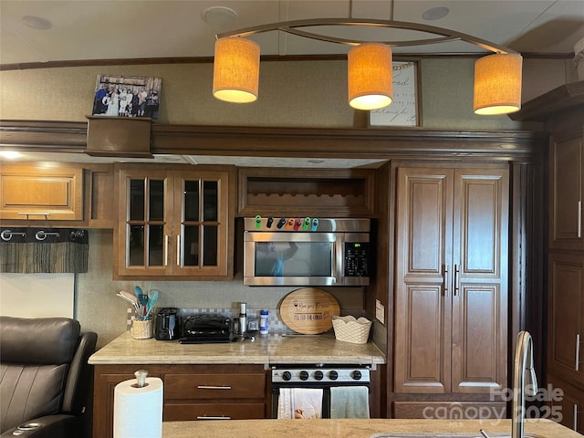 5400 Little River Neck Rd Unit 169, North Myrtle Beach, SC 29582 - kitchen with stainless steel microwave, wall oven, glass insert cabinets, crown molding, and a sink