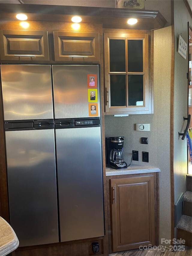 5400 Little River Neck Rd Unit 169, North Myrtle Beach, SC 29582 - kitchen featuring stainless steel fridge, light countertops, and glass insert cabinets