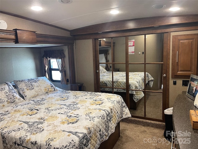 5400 Little River Neck Rd Unit 169, North Myrtle Beach, SC 29582 - bedroom with lofted ceiling and carpet flooring
