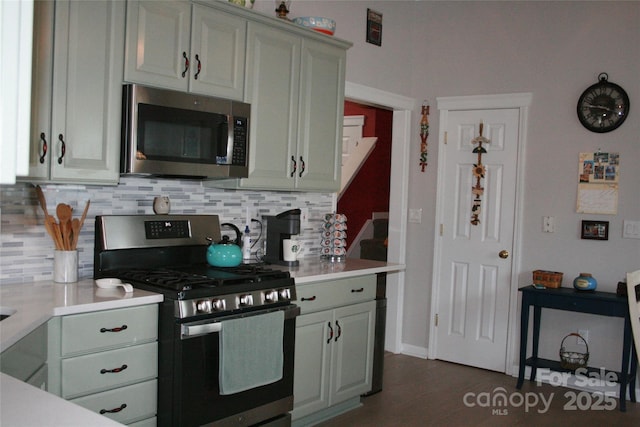 4711 Lenox Hill Pl Unit 98, Charlotte, NC 28269 - kitchen featuring stainless steel appliances, decorative backsplash, light countertops, and dark wood-style floors