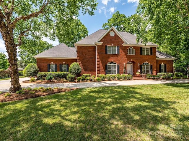1209 S S St, Gastonia, NC 28052 - colonial inspired home with brick siding, a front lawn, and a shingled roof