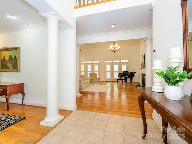 1209 S S St, Gastonia, NC 28052 - foyer entrance with decorative columns, ornamental molding, light wood finished floors, a chandelier, and baseboards