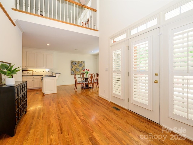 1209 S S St, Gastonia, NC 28052 - entryway featuring light wood-style floors, a towering ceiling, and recessed lighting