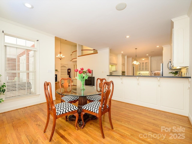 1209 S S St, Gastonia, NC 28052 - dining space with light wood-style floors, a chandelier, recessed lighting, crown molding, and baseboards