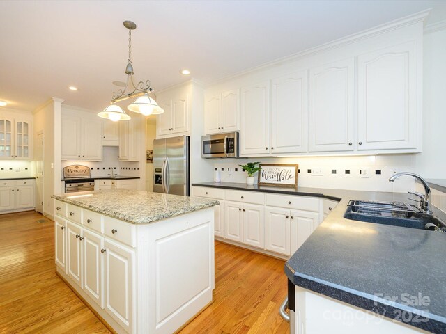 1209 S S St, Gastonia, NC 28052 - kitchen featuring stainless steel appliances, a sink, white cabinets, light wood finished floors, and recessed lighting