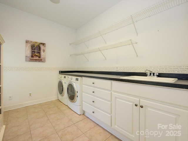 1209 S S St, Gastonia, NC 28052 - washroom with washing machine and dryer, a sink, light tile patterned floors, and baseboards
